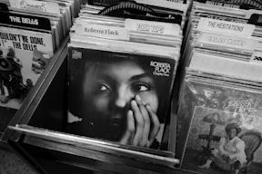 woman in black shirt in front of books