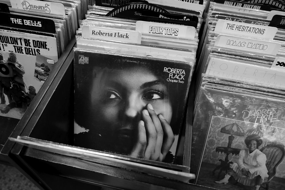 woman in black shirt in front of books