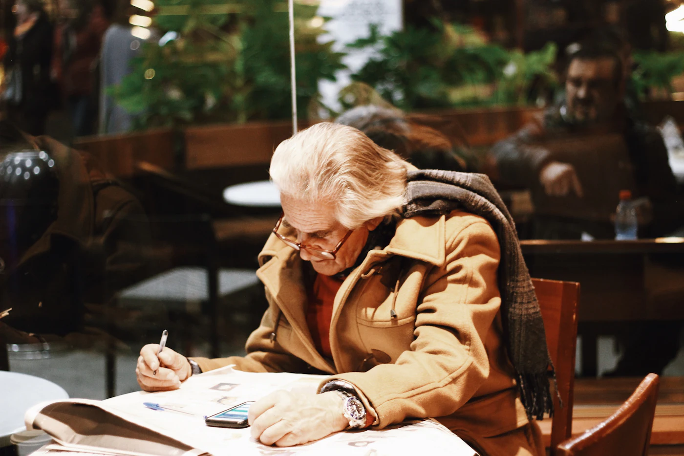 A person writing by hand at a desk
