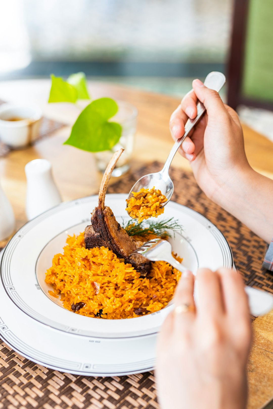 person holding stainless steel fork and spoon