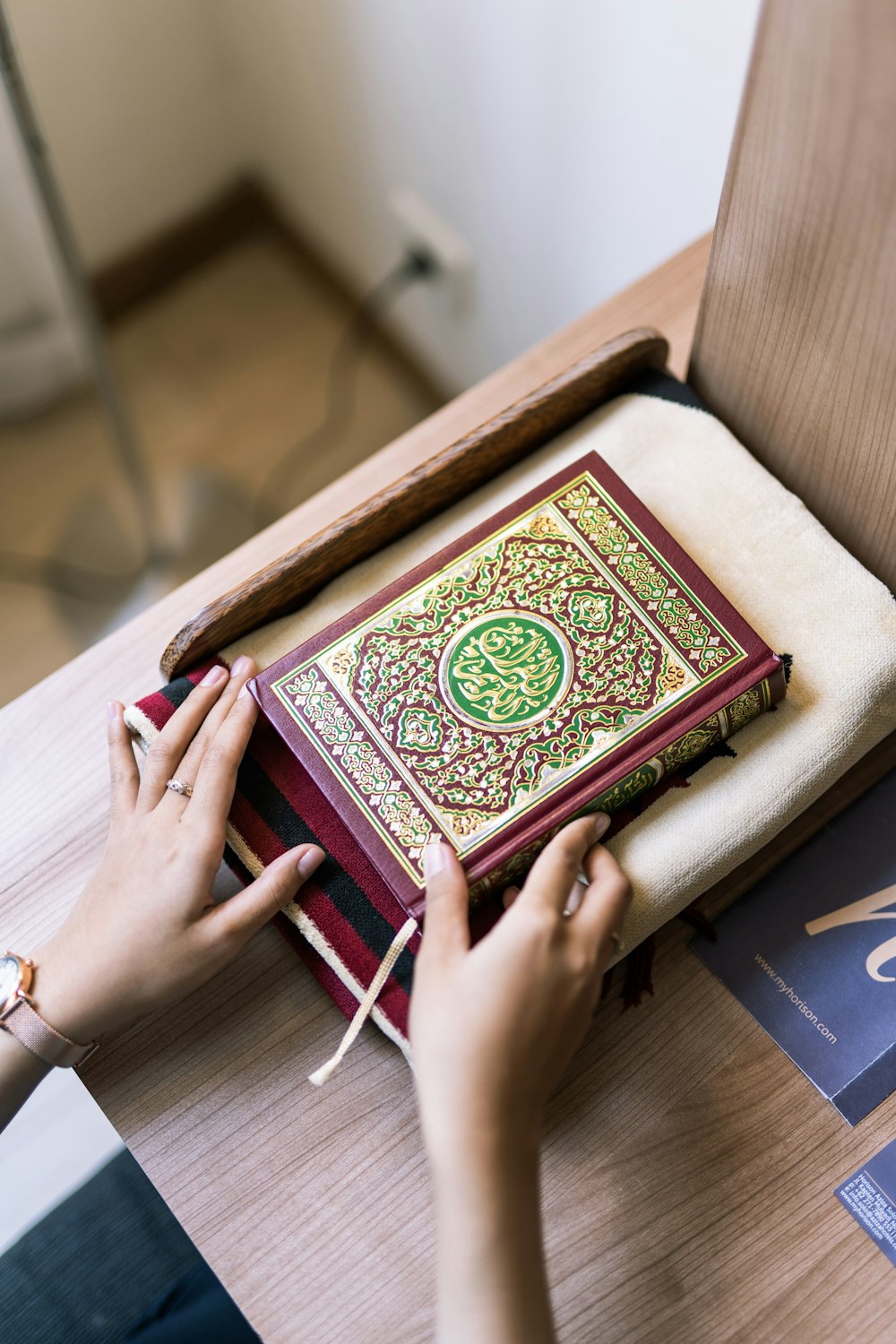 person holding green and brown hardbound book