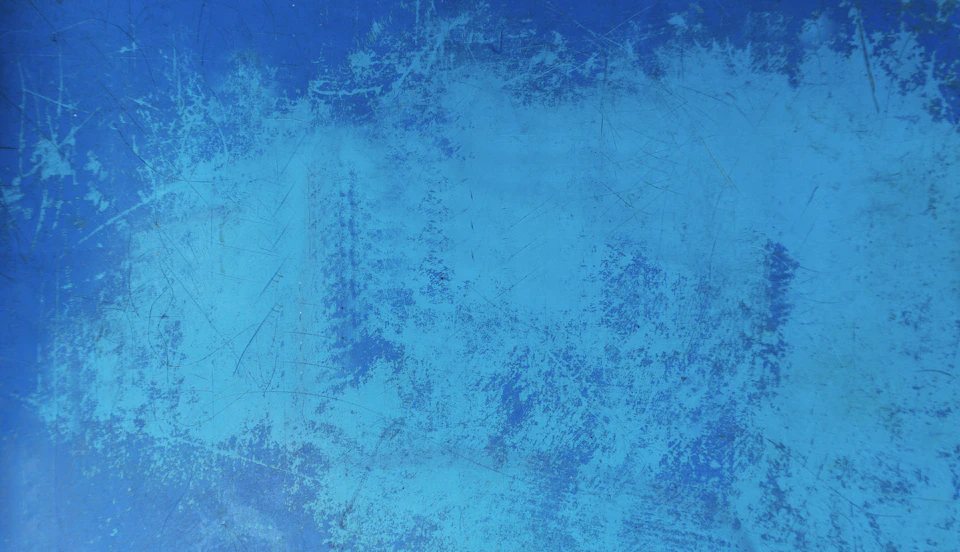 Abstract painting with blue background and white splatters on a rectangular canvas surface