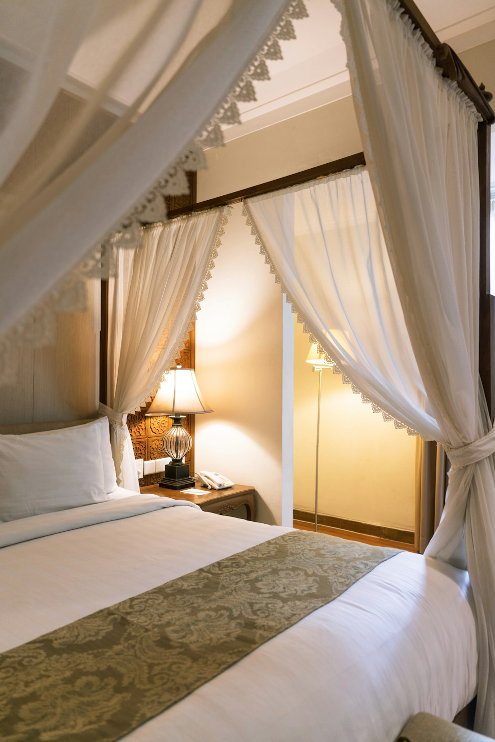 white bed linen near brown wooden table