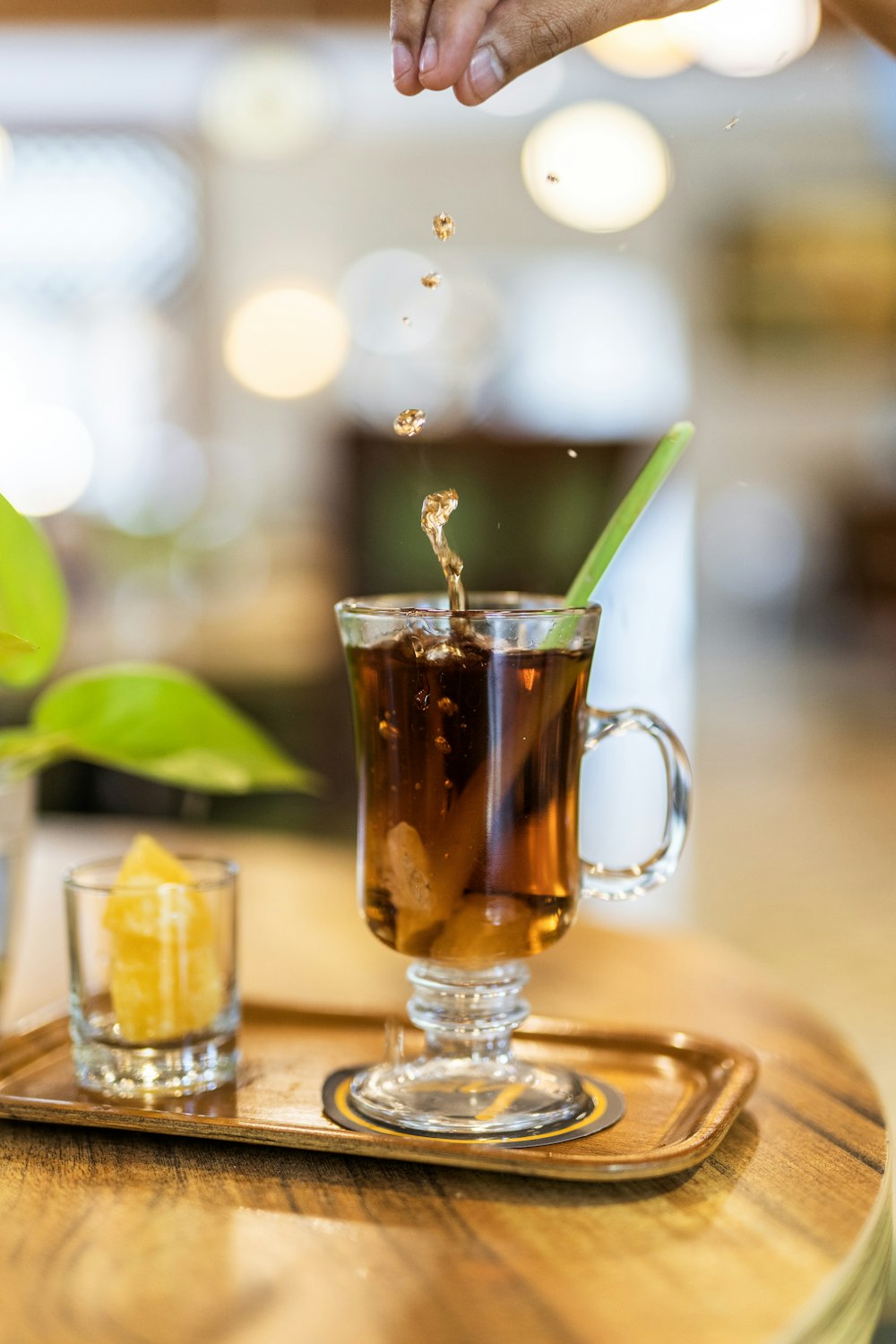 clear glass mug with brown liquid