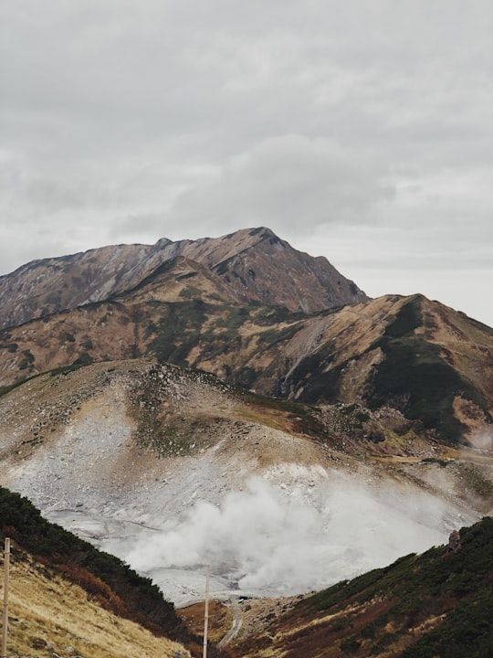 brown and green mountains under white clouds during daytime in Mount Tate Japan