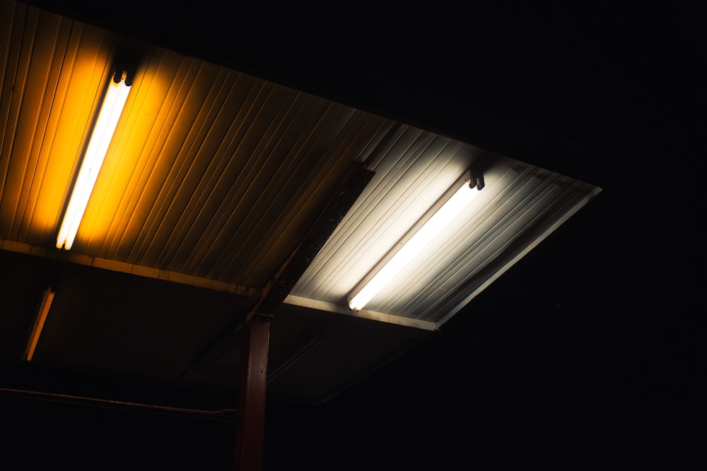 white light on brown wooden ceiling
