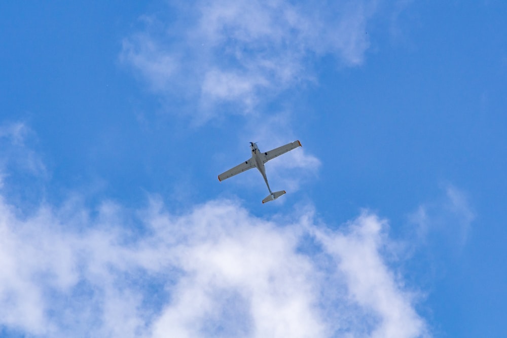 white plane in mid air during daytime
