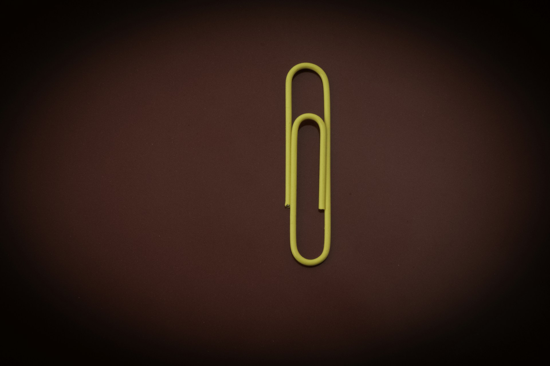 yellow paper clip on red textile