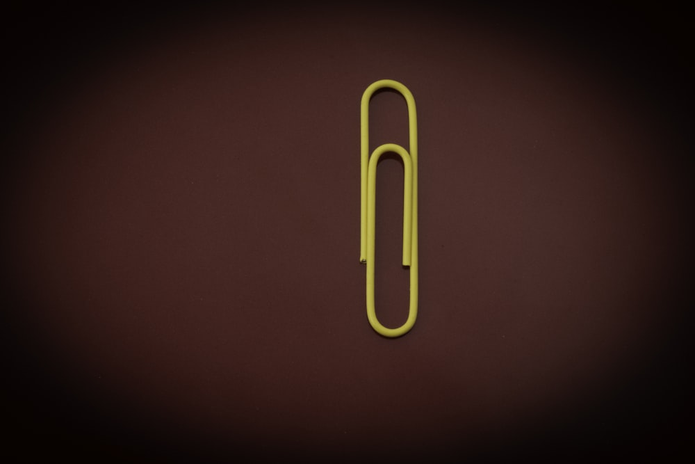 yellow paper clip on red textile