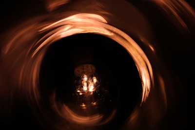 A glowing lightbulb surrounded by swirling colors symbolizing creative inspiration.