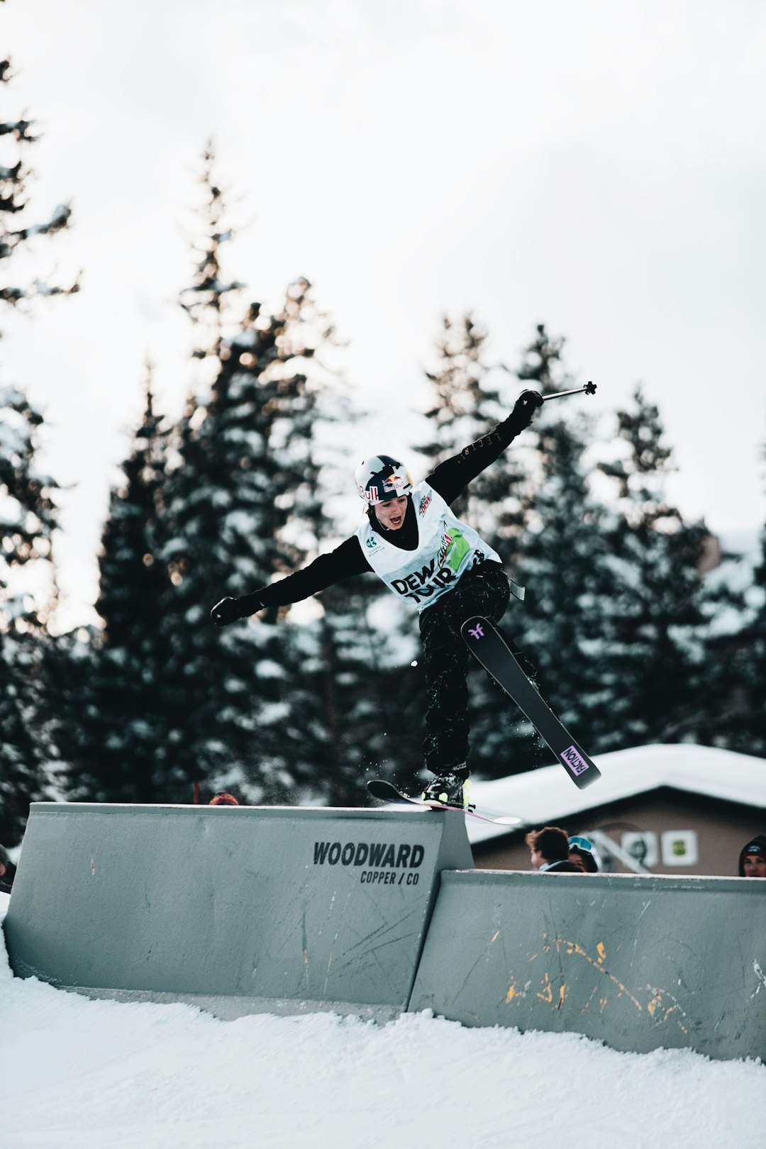 man in black and white jacket riding on black snowboard during daytime