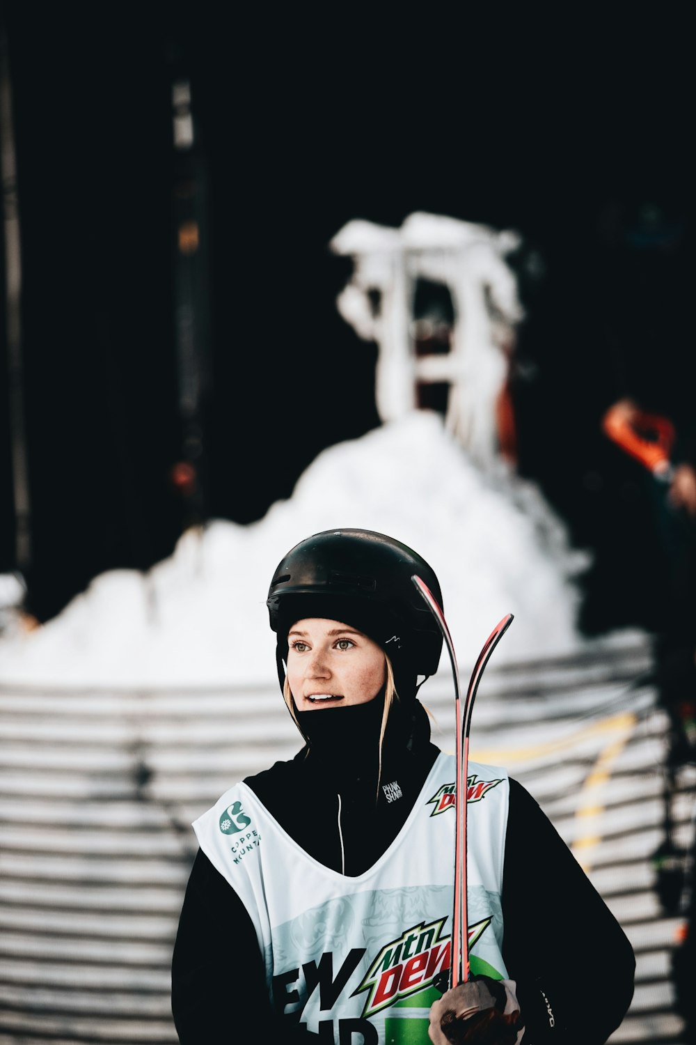 woman in white and red jacket wearing black helmet