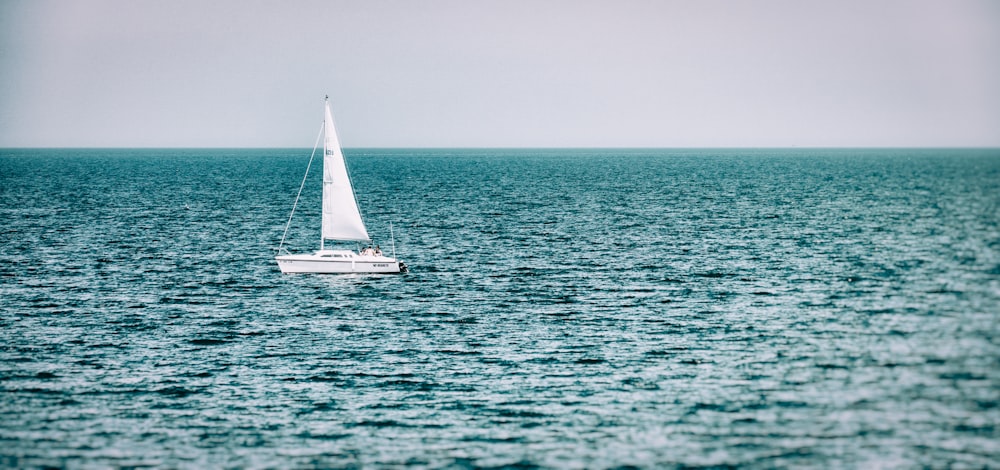 white sailboat on sea during daytime