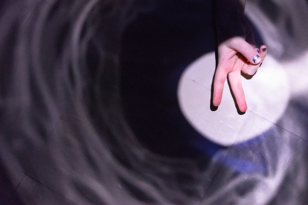 person holding black round textile