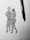 A black ink drawing on white paper depicts two abstract human figures embracing or dancing. The sketching style is rough and dynamic, capturing a sense of movement and connection. A black pen is placed beside the drawing, suggesting the tool used to create it.