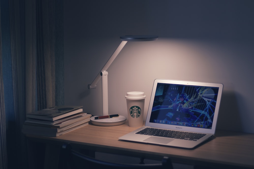 macbook pro on brown wooden table