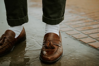 Warm winter boots paired with breathable summer loafers on a contrasting surface.