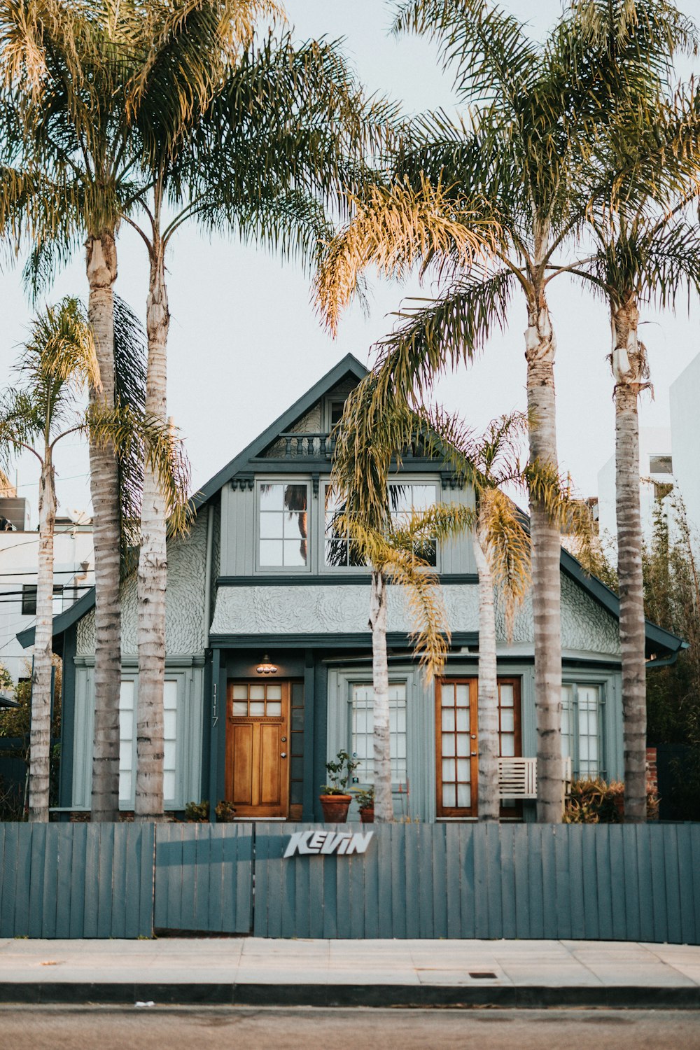 white and brown concrete house near palm tree during daytime