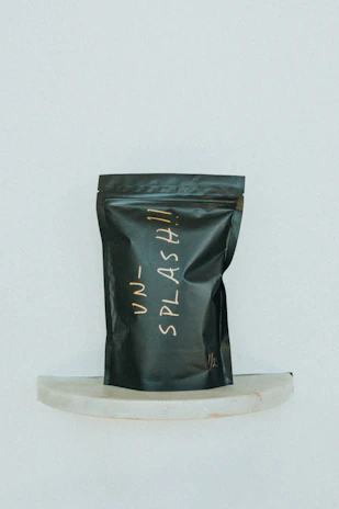 Close-up of a glossy label with a sleek logo on a pet treat pouch.