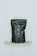 A black, matte-finished stand-up pouch with handwritten lettering in a light, cursive style is displayed against a minimalist background. The pouch is positioned on a small, semi-circular marble shelf and bears the word 'UNSPLASH!!' in an off-white color.