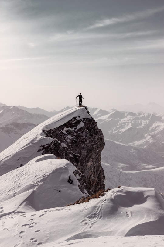 person standing on top of mountain during daytime in Les Contamines-Montjoie France