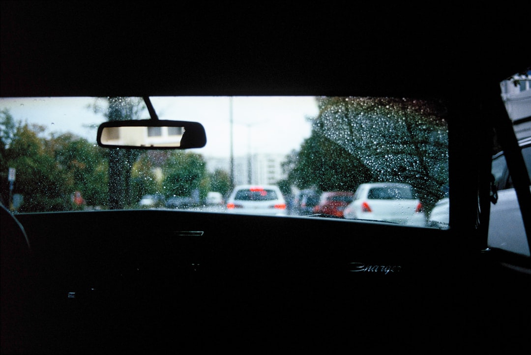 black flat screen tv turned on displaying white car