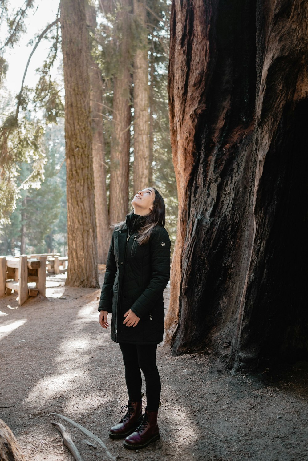 woman in black jacket standing in the middle of the road