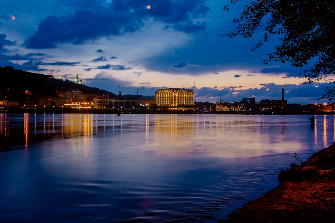 city skyline across body of water during night time