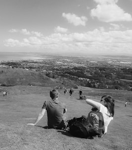 A happy couple enjoying a scenic view on a budget-friendly trip.
