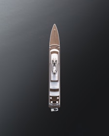 A project manager reviewing blueprints with a team beside a large aluminum yacht.