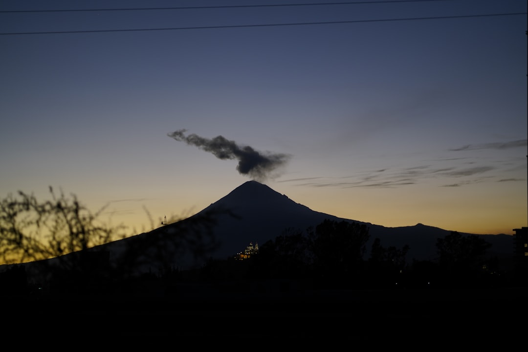 silhouette of mountain under blue sky during daytime