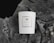 A white ceramic candle with a minimalist label, placed on the textured surface of a tree stump. The label reads '360 Wishes' and describes a hand-poured soy candle of 220ml capacity.
