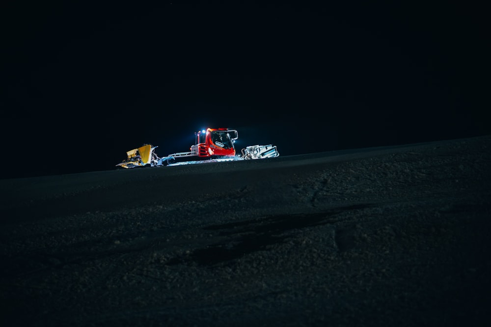 red and white formula 1 on snow covered ground during night time