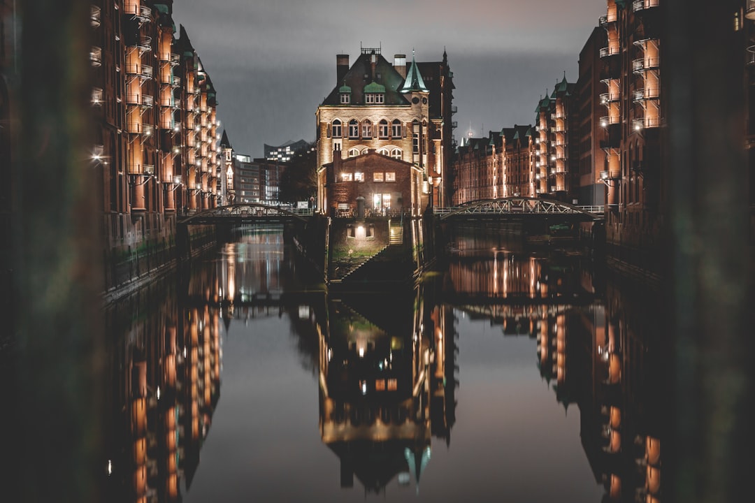 brown concrete building near body of water during night time