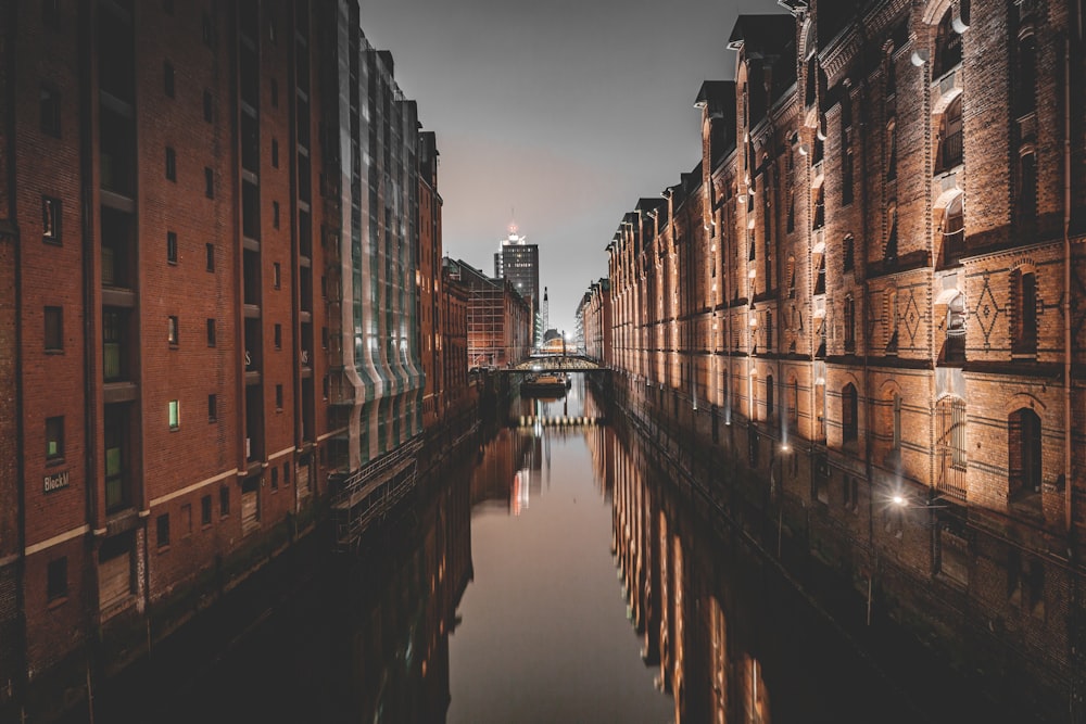 brown concrete building beside river during daytime