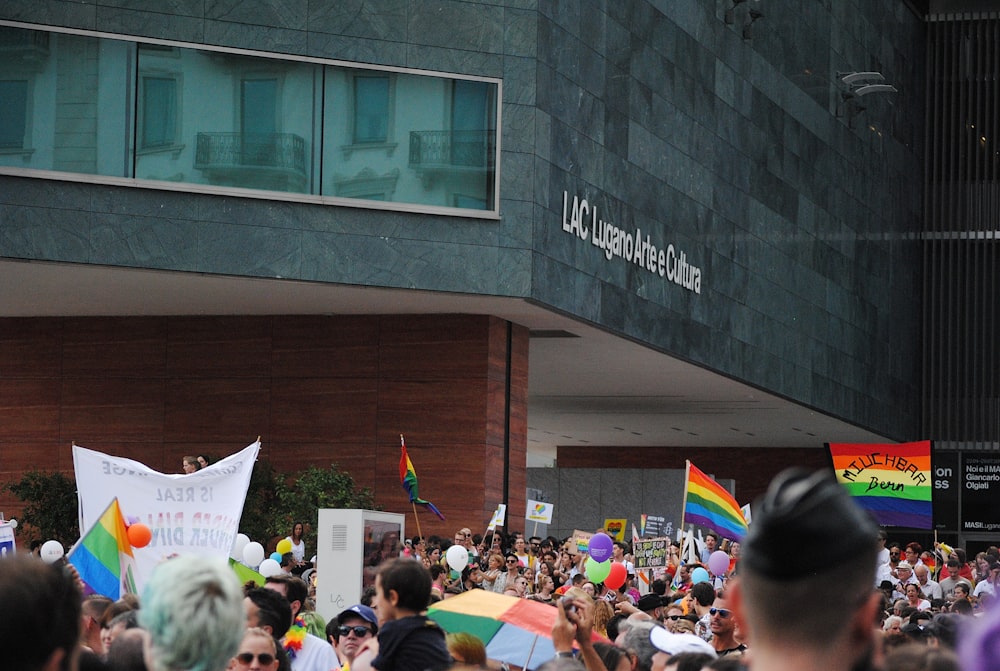 people gathering in front of building during daytime