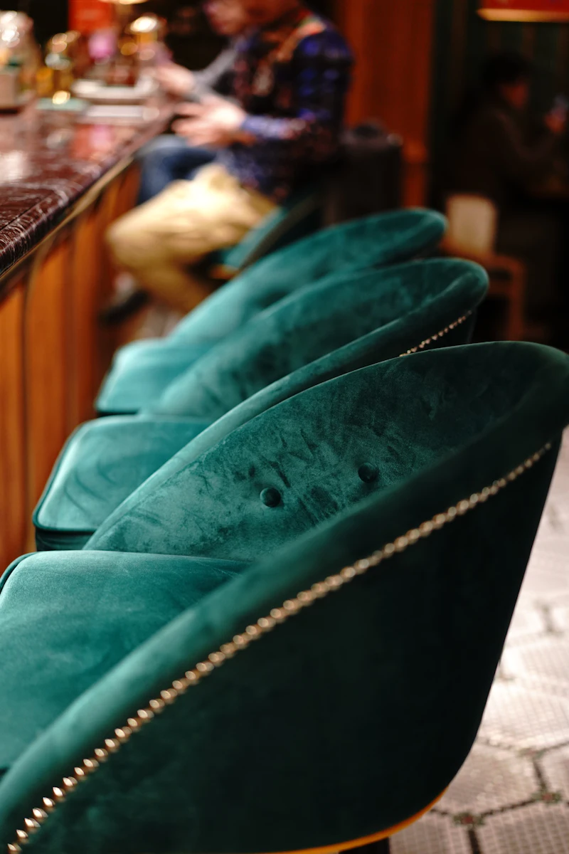 Custom wooden chair with green leather seat