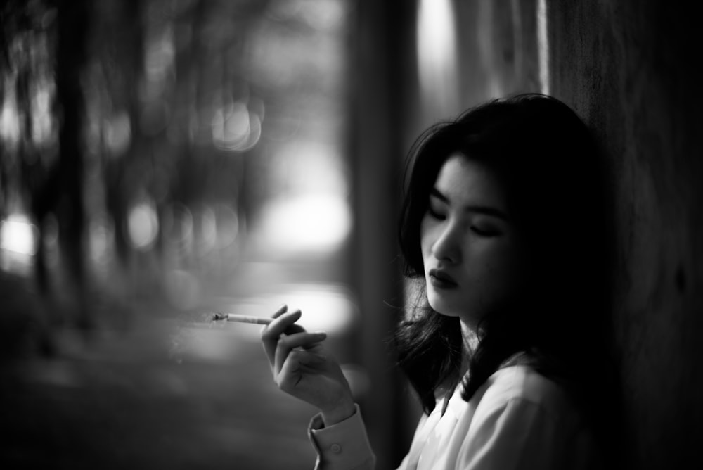 woman in white shirt smoking cigarette