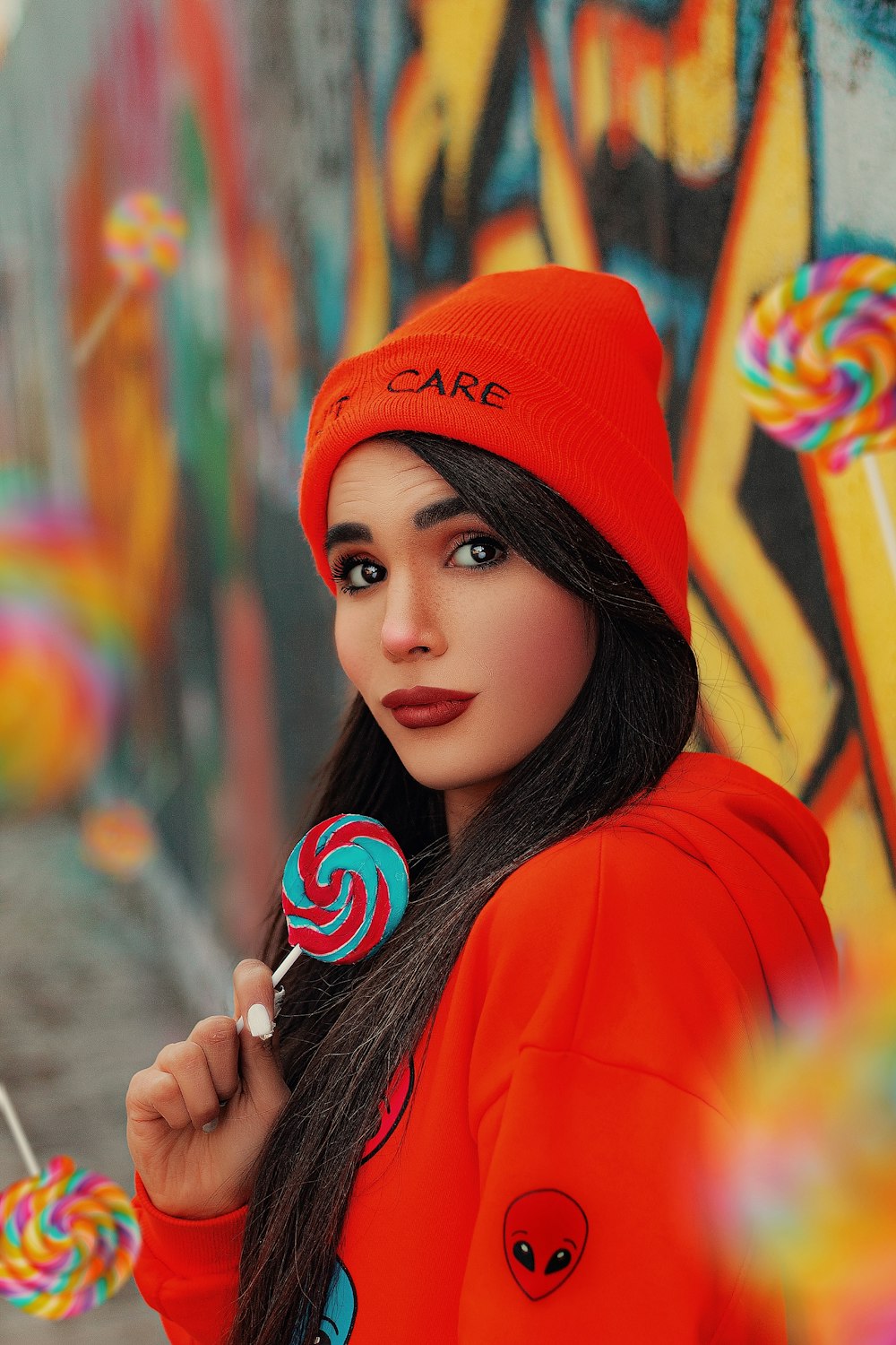 woman in orange knit cap and orange hoodie