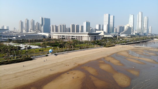people walking on beach near high rise buildings during daytime in Siming China