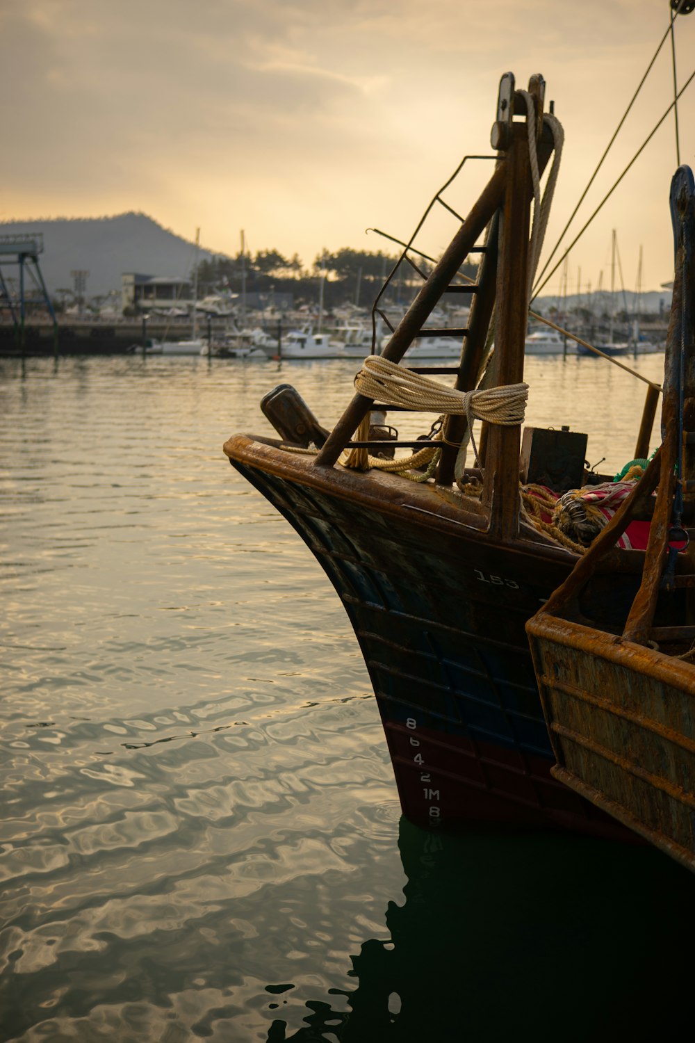 brown wooden boat on body of water during daytime