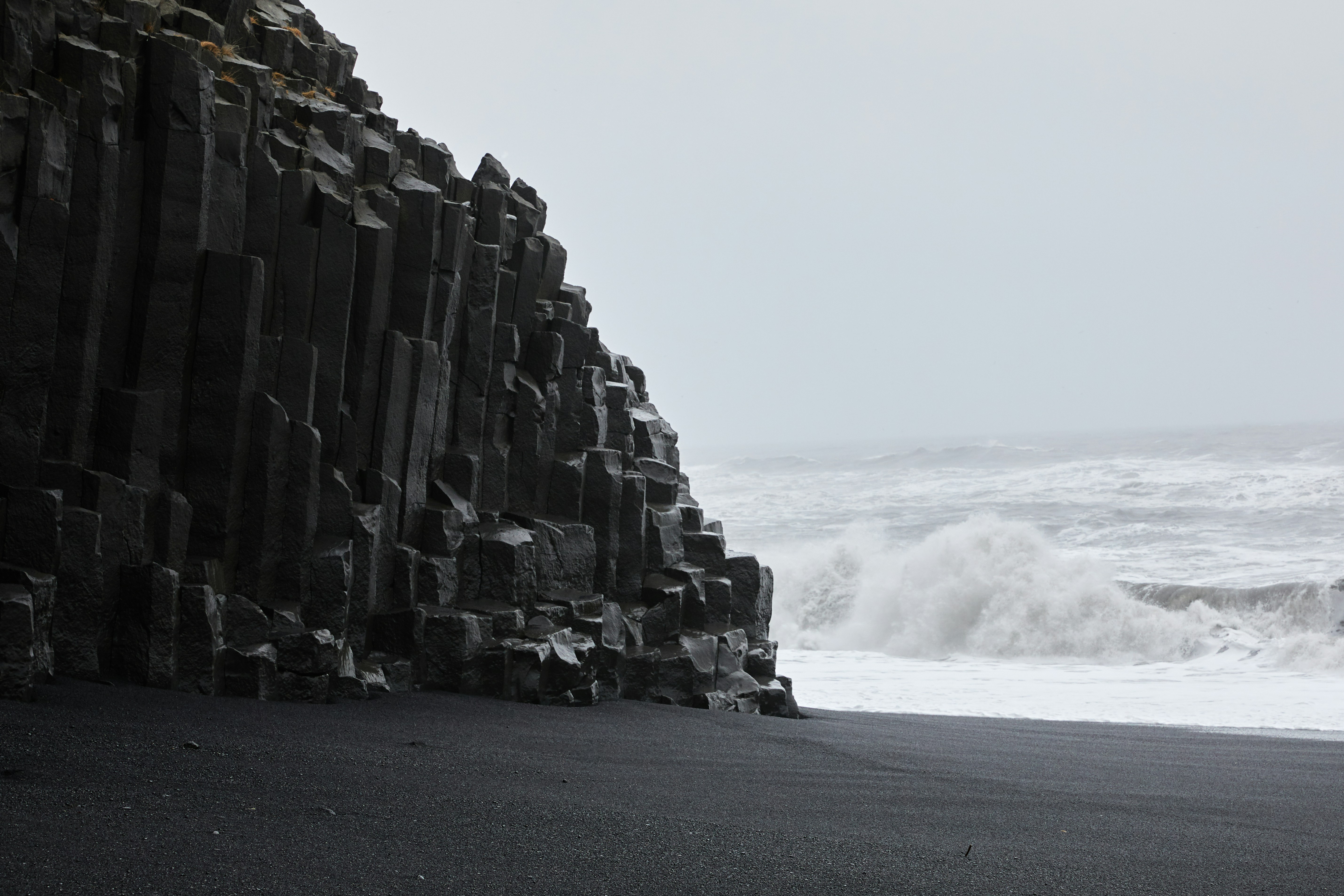 gray rock formation on gray sand during daytime