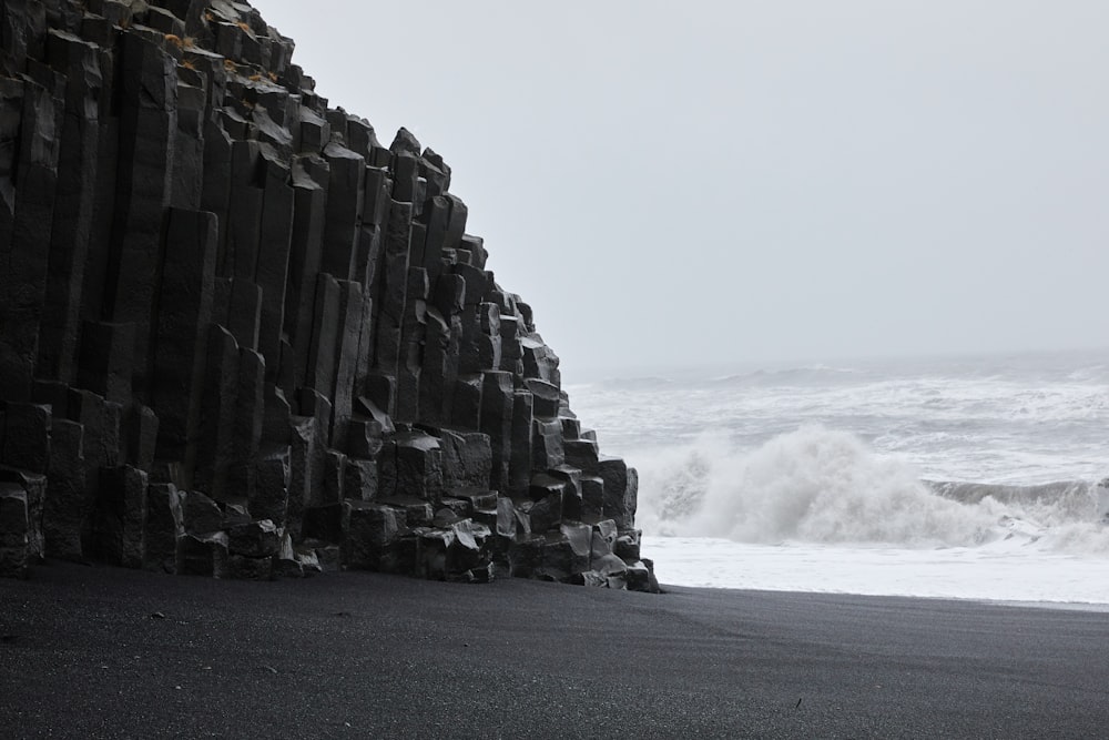 gray rock formation on gray sand during daytime