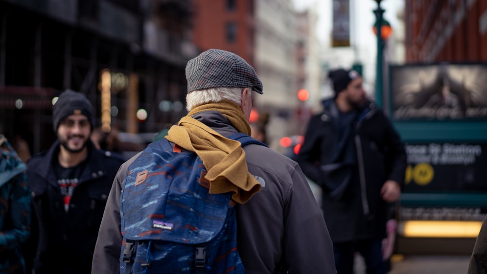 man in blue denim jacket and brown knit cap