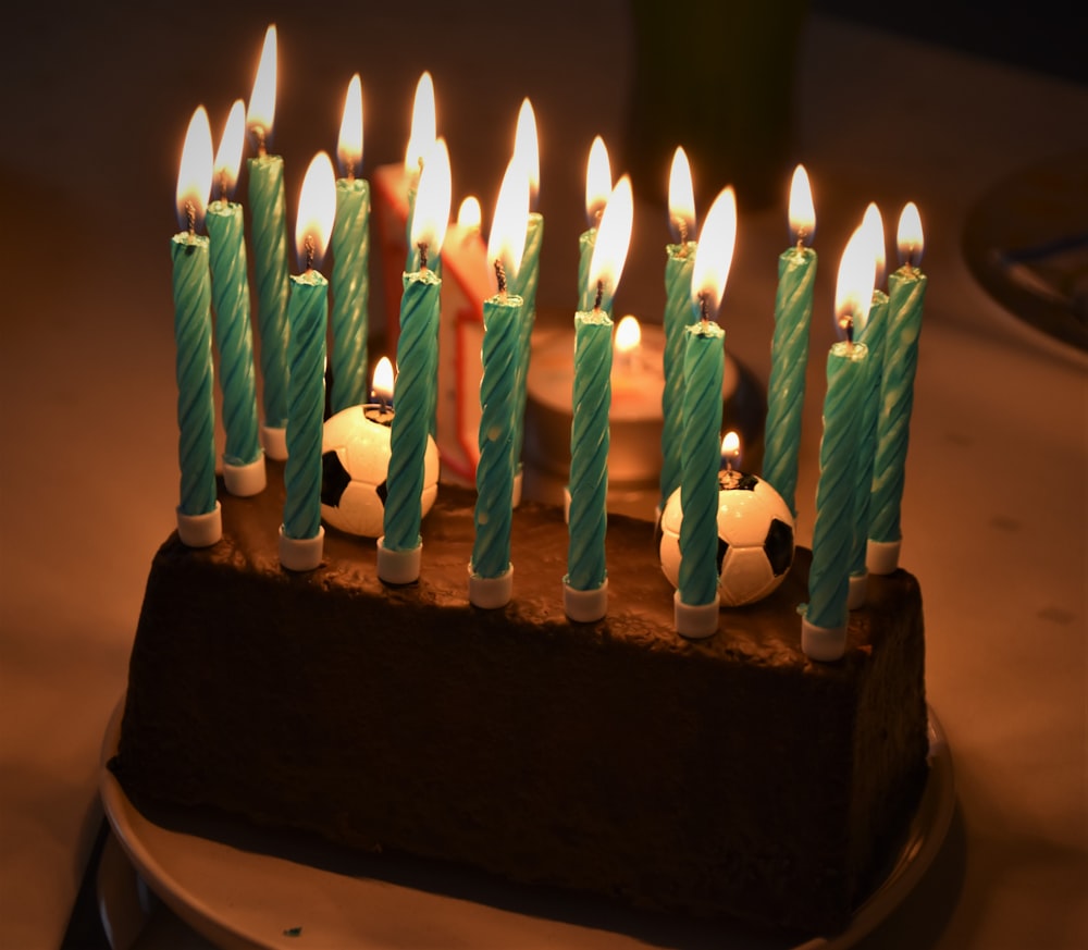 green candles on brown cake