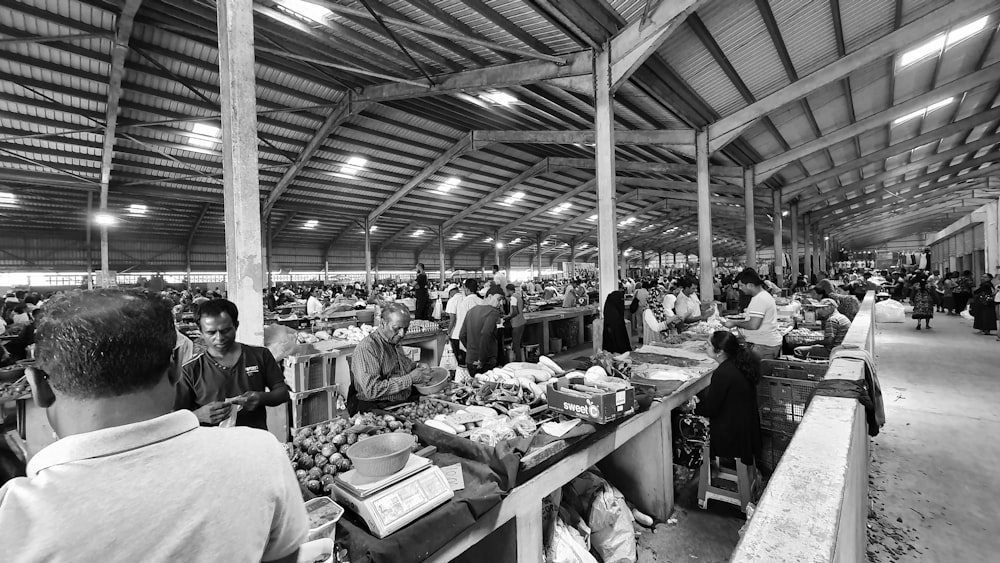 grayscale photo of people in market