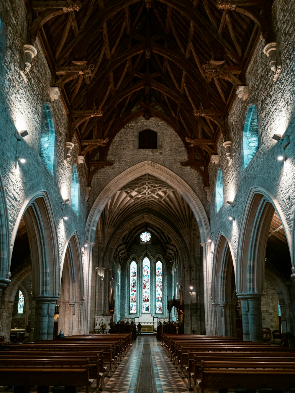 a church with pews and stained glass windows