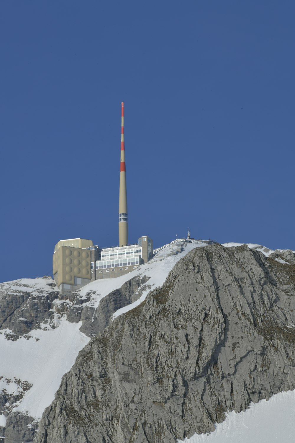 산 꼭대기에 흰색과 빨간색 타워