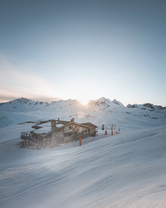 brown wooden house on snow covered ground during daytime in Val-d'Isère France