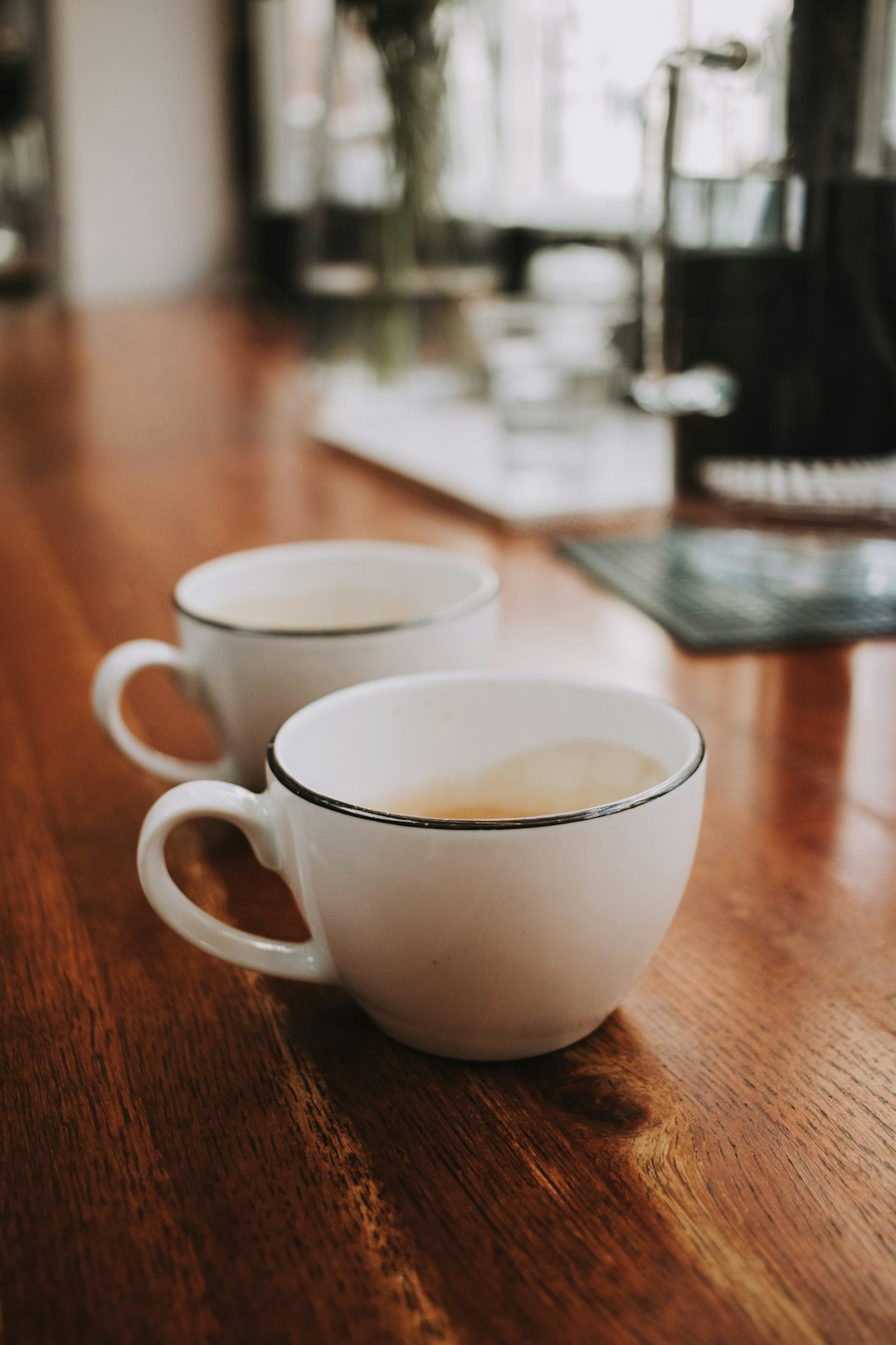 white ceramic cup on brown wooden table